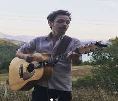 He enjoys playing guitar in his spare time.